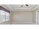 Neutral primary bedroom features a tray ceiling, window coverings, and plush carpeting at 13499 Molique Blvd, Fishers, IN 46037