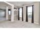 Open-concept dining area featuring neutral tones, large windows with dark curtains, and chandelier at 13499 Molique Blvd, Fishers, IN 46037