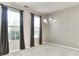 Inviting dining room with neutral walls, a chandelier, and large windows with elegant dark curtains at 13499 Molique Blvd, Fishers, IN 46037