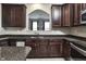 Beautiful kitchen featuring granite countertops, stainless steel appliances, and dark wood cabinets at 13499 Molique Blvd, Fishers, IN 46037