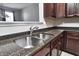 Kitchen features stainless steel sink, granite countertops, and brown cabinets at 13499 Molique Blvd, Fishers, IN 46037
