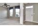 Bright, airy living room featuring neutral walls, a ceiling fan, and a light-filled window at 13499 Molique Blvd, Fishers, IN 46037