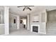 Open living space with a fireplace, staircase, and views of the kitchen area at 13499 Molique Blvd, Fishers, IN 46037