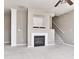 Living room with a fireplace, staircase, and gray carpeting illuminated by recessed lighting at 13499 Molique Blvd, Fishers, IN 46037