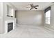 Neutral living room with fireplace, ceiling fan, and large windows for natural light at 13499 Molique Blvd, Fishers, IN 46037