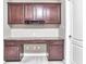 Home office nook with built-in desk, drawers, shelving, and overhead cabinets at 13499 Molique Blvd, Fishers, IN 46037