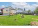 Backyard view from the home, features a wood deck, a wood fence, and grass at 1426 S Anderson St, Elwood, IN 46036
