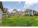 Backyard with a raised deck, wood fence, and grassy lawn at 1426 S Anderson St, Elwood, IN 46036