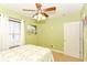 Comfortable bedroom with ceiling fan and lots of natural light through the window at 1426 S Anderson St, Elwood, IN 46036