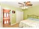Bedroom featuring neutral walls, ceiling fan, and double door closet at 1426 S Anderson St, Elwood, IN 46036