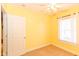Bright bedroom features a ceiling fan, one window with coverings, and neutral carpet at 1426 S Anderson St, Elwood, IN 46036