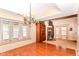 Elegant dining room features hardwood floors, large windows, and a view into the cozy living room at 1426 S Anderson St, Elwood, IN 46036