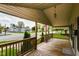 Inviting covered front porch with wooden flooring and railings, providing a relaxing outdoor space at 1426 S Anderson St, Elwood, IN 46036