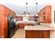 Well-equipped kitchen features dark cabinets, granite countertops, and modern appliances at 1426 S Anderson St, Elwood, IN 46036