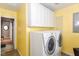 Bright laundry room with white cabinets and modern washer and dryer at 1426 S Anderson St, Elwood, IN 46036