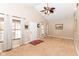 Bright living room with neutral walls, large windows, vaulted ceilings, and a ceiling fan at 1426 S Anderson St, Elwood, IN 46036