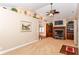 Spacious living room featuring a cozy fireplace, large shelving, and vaulted ceilings at 1426 S Anderson St, Elwood, IN 46036