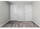 Neutral bedroom showcasing two bright white doors with modern gray paint and neutral carpet at 15447 Gallow Ln, Noblesville, IN 46060
