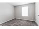 Bedroom with neutral walls, plush carpet, window, and white doors at 15447 Gallow Ln, Noblesville, IN 46060