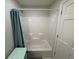 Bright white bathroom with white shower and turquoise shelf at 155 N Franklin Rd, Indianapolis, IN 46219