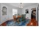 Well-lit dining room features hardwood floors and a built in china cabinet at 155 N Franklin Rd, Indianapolis, IN 46219