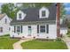 Inviting home with a lush green lawn, quaint landscaping, and a charming pathway leading to the front door at 155 N Franklin Rd, Indianapolis, IN 46219