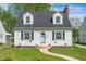 Charming two-story home featuring a well-manicured lawn, bright white siding, and a welcoming front entrance at 155 N Franklin Rd, Indianapolis, IN 46219