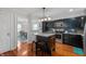 Spacious kitchen boasts dark cabinetry, an island with seating, and hardwood floors at 155 N Franklin Rd, Indianapolis, IN 46219