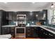 Modern kitchen features stainless steel appliances, dark cabinets, and sleek countertops at 155 N Franklin Rd, Indianapolis, IN 46219