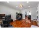 Spacious office with hardwood floors, multiple desks, and a view into a living space at 155 N Franklin Rd, Indianapolis, IN 46219