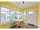 Bright sunroom with lots of windows, a table and chairs, and colorful decor at 155 N Franklin Rd, Indianapolis, IN 46219