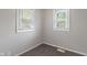 A corner of a bedroom that features two windows and brown carpet at 1602 Villa Ave, Indianapolis, IN 46203