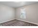 This bedroom has paneled walls with simple window and brown carpet at 1602 Villa Ave, Indianapolis, IN 46203