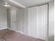 A simple bedroom features neutral walls, basic carpet, and closet with sliding doors at 1602 Villa Ave, Indianapolis, IN 46203
