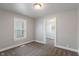 This bedroom is painted in neutral tones with a window and brown carpet at 1602 Villa Ave, Indianapolis, IN 46203