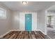 Entryway features hardwood floors and a blue front door with stylish window detail at 1602 Villa Ave, Indianapolis, IN 46203