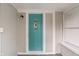 Entryway with gray walls, white trim, and bright blue front door with window at 1602 Villa Ave, Indianapolis, IN 46203