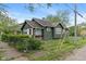 View of home with green wood siding, green shingles, chain link fence and nice yard at 1602 Villa Ave, Indianapolis, IN 46203