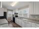 A bright kitchen features white cabinets, a black range, and a double basin sink at 1602 Villa Ave, Indianapolis, IN 46203