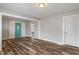 Open living room area boasts hardwood floors, gray walls, and bright blue entry door at 1602 Villa Ave, Indianapolis, IN 46203