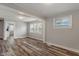 Living room with hardwood floors, neutral gray walls, and large window at 1602 Villa Ave, Indianapolis, IN 46203