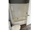 A well-lit bathroom features a tub and shower combination with built-in shelving, providing convenient storage solutions at 1715 S Madison St, Muncie, IN 47302