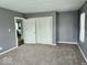A cozy bedroom features plush carpet flooring and a large closet, creating a comfortable and inviting space at 1715 S Madison St, Muncie, IN 47302