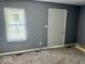 Bedroom featuring a window with blinds and carpet at 1715 S Madison St, Muncie, IN 47302