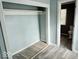 View of a closet with gray flooring and view of a bathroom in need of renovation at 1715 S Madison St, Muncie, IN 47302