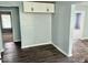 A quaint dining room features dark wood vinyl flooring and white cabinetry providing a cozy atmosphere for dining at 1715 S Madison St, Muncie, IN 47302