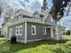Lovely home featuring gray siding, white trim, and well-maintained landscaping at 1715 S Madison St, Muncie, IN 47302