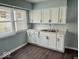 Kitchen featuring sleek white cabinets, ample counter space, and natural light from a nearby window at 1715 S Madison St, Muncie, IN 47302
