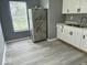 Kitchen with stainless steel appliances and white cabinets, natural light at 1715 S Madison St, Muncie, IN 47302