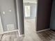 Open living room space featuring modern gray flooring, window, and gray walls at 1715 S Madison St, Muncie, IN 47302